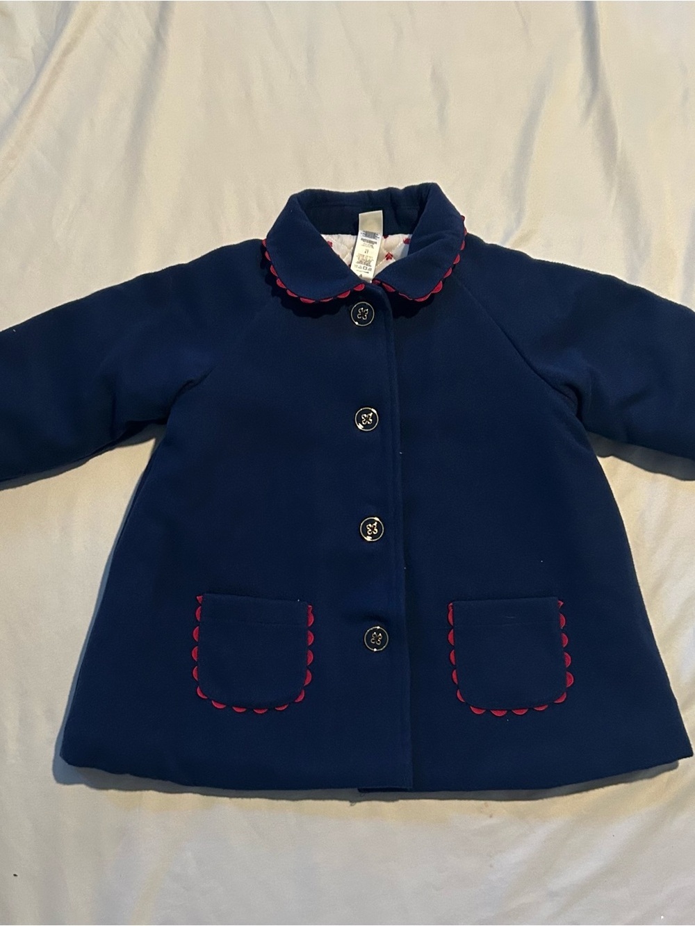 Little Me Navy Pea Coat with Red Scallop Trim and Bow.